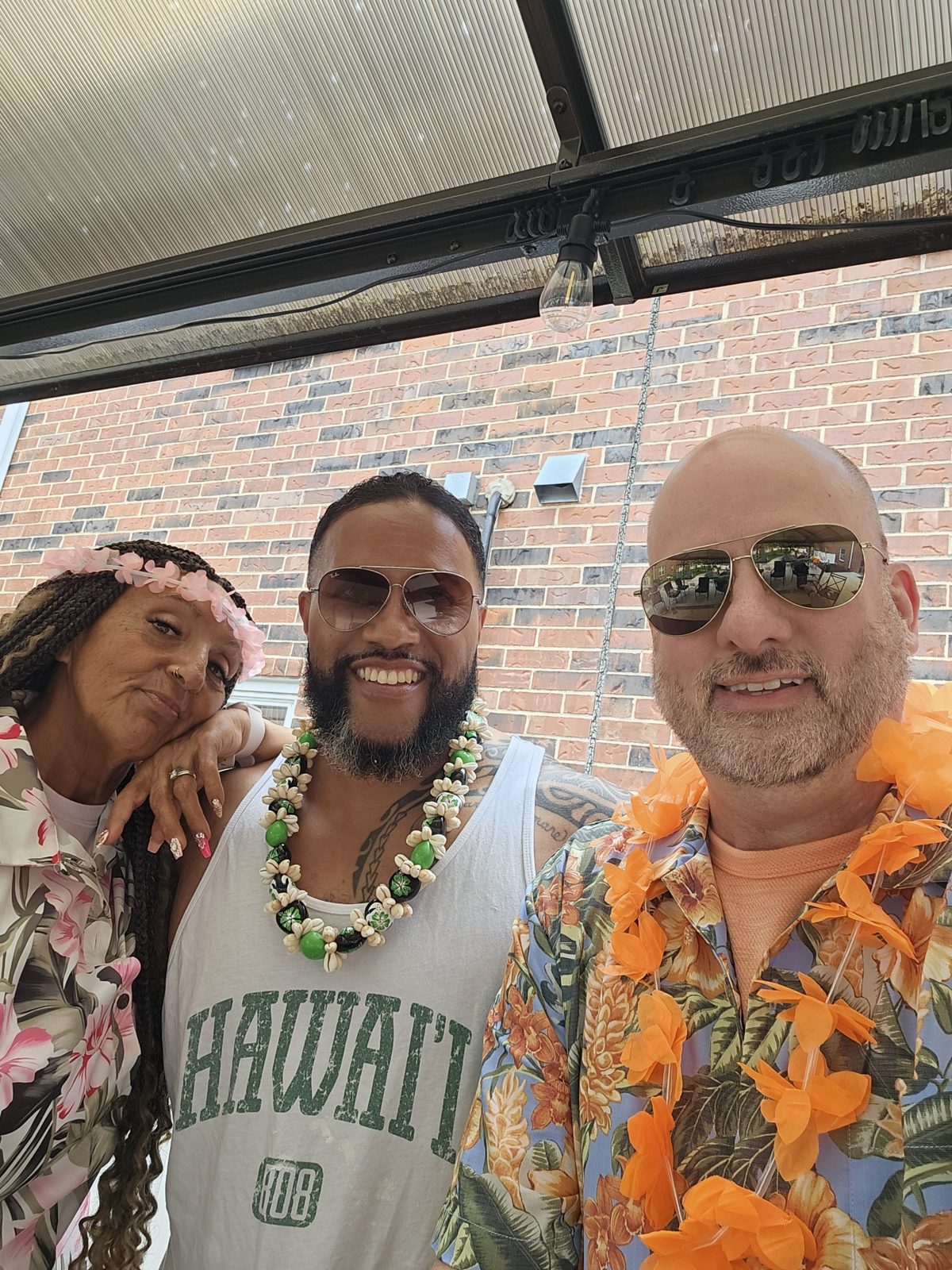 DJ Sir Uso wearing a traditional Polynesian lei at a luau-themed party for a senior living community and corporate group in the St. Louis area